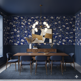 Midnight Magnolie Wallpaper in blue with white floral pattern over a paneled wainscoting wall.
