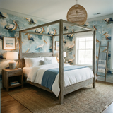 Pelican patterned wallpaper from York Wallcoverings, with blue and beige shades in a coastal bedroom setting.