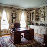 Dog-patterned Yama Ridge Wallpaper with dogs of various breeds on the wall behind a wooden desk.