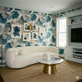 Tidal Organics wallpaper with blue botanical leaf pattern, covering the walls in an interior living space.