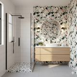 Verona Verde wallpaper featuring a colorful terrazzo pattern, covering the bathroom walls and matching the shower floor.

