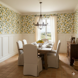 Lemon-patterned Provençal Olive Wallpaper featuring green foliage and yellow citrus, accenting white wainscoting in a traditionally styled dining room.
