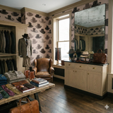 Milliner's Table Wallpaper with hat pattern, covering the wall, in a retail setting.