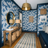 Blue rope study wallpaper with white details, patterned walls, and wooden table.
