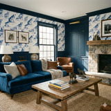 Howlcrest Ridge wallpaper with wolf pattern from Wallshoppe in a rustic, warmly decorated living room.