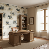 Elephant-patterned wallpaper with watercolor effect over tan background featuring office furniture and a tan rug.