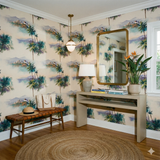 Griffith Mirage Wallpaper, palm trees and building pattern, covers a foyer with a round jute rug.