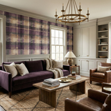 Mauvine Crosscut wallpaper by York Wallcoverings featuring a purple plaid pattern on a wall in a living room.
