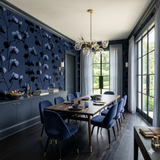 Moonlit Reverie Wallpaper featuring floral pattern, dark blue backdrop, and contrasting black orchid design.
