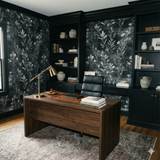 Botanique wallpaper in black and white floral pattern, Havenshade Botanique Wallpaper, covering the walls in a home office.
