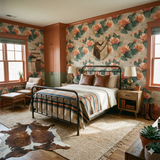 Cactus blossom wallpaper with peach flowers on a textured gray background, surrounding a southwestern style bedroom.
