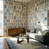 Mesa Ledger patterned wallpaper by Wallshoppe, featuring blue and brown vertical brushstroke accents.