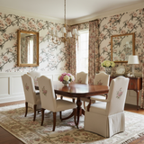 Floral camellia wallpaper with blooming vines, complemented by matching curtains and elegant traditional dining room decor.