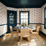 Coquette wallpaper with blue ribbon pattern on a light background, styled in dining room.