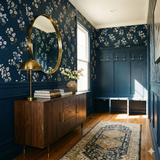 Floral wallpaper with a blue background by Vera Grace, featuring a white and brown flower pattern.