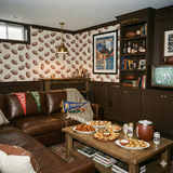 Gridiron Etching Room Wallpaper with football pattern on a light background, visible in a stylized room.
