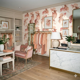 Salt Creek Muse wallpaper with pink and cream tones, featuring a repeating pattern of women’s portraits.