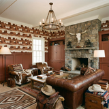 Mesa Textile Horizon Wallpaper with a desert butte pattern, styled in a western-themed living room.
