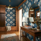 Indigo Fieldhouse Wallpaper with foliage pattern over blue backdrop.