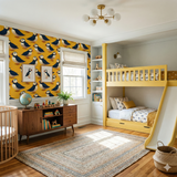 Patterned Eiderdown Parade wallpaper with puffin design, showcased on a yellow wall.
