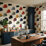 Repeating baseball cap pattern wallpaper covering a home office wall.