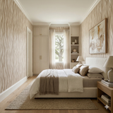 Woven dune wallpaper with wavy vertical pattern and neutral color, featured in a bedroom setting.