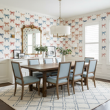 Penny Harbor wallpaper with red and blue bow pattern, covering a dining room wall.
