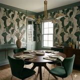 Patterned wallpaper featuring a leaf design, displaying dark green and off-white tones.