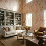 Floral wallpaper with peachy blooms, styled in an interior setting with neutral furniture.