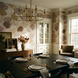Floral canopy wallpaper with a leaf pattern, covering the walls in a traditional dining room.