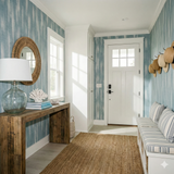 Blue and white striped wallpaper of linen from Brewster, in a coastal-inspired hallway.