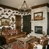 Cowboy hat print wallpaper with brown trim and western-themed decor.