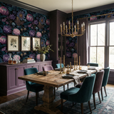 Floral wallpaper with purple and blue hues, with dark moody botanical pattern.
