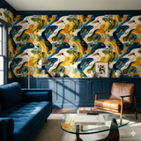 Abstract patterned Ochre Estuary Wallpaper with yellow and blue details, set in a styled living room scene.