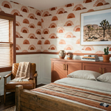 Caldera Rise Wallpaper with terracotta sun pattern against an off-white backdrop.
