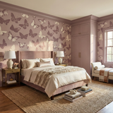 Pale Monarch wallpaper with butterfly pattern on an accent wall, a bedroom interior detail.