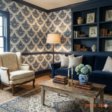 Navy patterned wallpaper with a floral medallion design, against off-white, covering the walls in a traditionally decorated room.