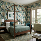 Eucalyptus Haze wallpaper with leafy pattern on the wall behind a wooden four-poster bed.