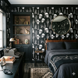 Desert Relic Nocturne wallpaper with black background, skulls and cactus design, in a styled room.