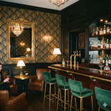 Gilded wallpaper with geometric fan pattern, gold on black background.