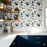Patterned wallpaper with a terrazzo design, featuring teal, mustard, and navy geometric shapes on a white background.
