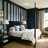 Blue floral striped wallpaper by Brewster Home Fashions in a traditionally styled bedroom.