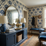 Indigo wallpaper from Linenfolk with a floral pattern covering the walls of a foyer.
