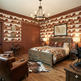 Textile wallpaper featuring a horizon pattern by Mesa, decorating a Western-style bedroom.