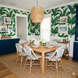Botanical wallpaper with banana leaf print pattern, covering the walls.