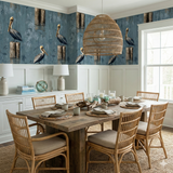 Wharf Rookery Wallpaper featuring pelicans on posts with reflections, coastal style, and a textured blue background.

