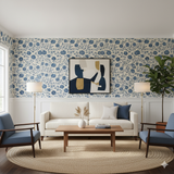 Floral indigo Dhalia wallpaper with a repeating floral pattern, covering the walls of a traditionally decorated living room.
