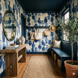 Blue and white patterned wallpaper with watercolor style jugs print, visible in a styled entryway.