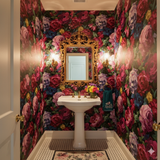 Floral rouge peony wallpaper with colorful roses by York Wallcoverings, covering a bathroom.