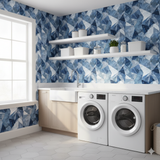 Blue geometric Frostvein Wallpaper with a faceted pattern, covering a laundry room wall.